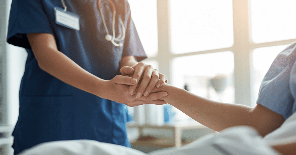 Nurse holding patient's hand, offering comfort